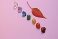 Chakra healing stones on pink millennial background