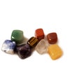 Chakra stones - natural cubic gems on a white background: jasper, tiger`s eye, charoite, lapis lazuli, agate, amethyst