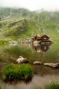 Chalet and Glacier Lake in Sibiu County in fog with reflection