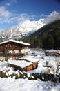 Chalet in French Alps in Chamonix with a panorama of mountains covered in snow in winter Royalty Free Stock Photo