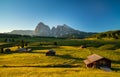 Chalets at Seiser Alm with Langkofel mountain in background at sunrise, Dolomites, South Tyrol, Italy Royalty Free Stock Photo