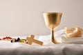 Chalice and consecrated host on table white isolated background Royalty Free Stock Photo