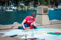 Chalk artist creating a piece of art in South Haven