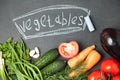 chalk board background with onion, garlic , parsley , cucumber , eggplant , tomato and dill. Top view Royalty Free Stock Photo