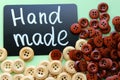 Chalk Board with the inscription `handmade` surrounded by brown and white wooden buttons Royalty Free Stock Photo