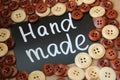 Chalk Board with the inscription `handmade` surrounded by brown and white wooden buttons Royalty Free Stock Photo