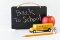 A chalk board with a message and items in front all to depict back to school. Royalty Free Stock Photo