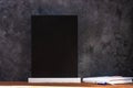 Chalk board mockup. Blackboard menu with easel on wooden table on a dark background. Copy space for adding text content Royalty Free Stock Photo