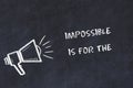 Chalk board sketch with loudspeaker and motivational phrase impossible is for the unwilling