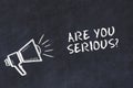 Chalk board sketch with loudspeaker and phrase are you serious Royalty Free Stock Photo