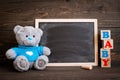 Chalk board and teddy bear on a wooden background Royalty Free Stock Photo