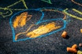 Chalk colored in the sun on a textured black floor