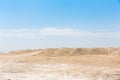 Chalk or Cretaceous quarry, sand or chalk hills against a bright blue sky