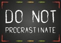 Chalk Do not procrastinate text on blackboard Royalty Free Stock Photo