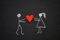 Chalk drawing man and woman holding together volumetric red hear