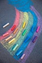 Chalk drawing. A rainbow painted on the asphalt with multicolored large crayons Royalty Free Stock Photo