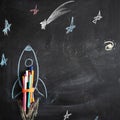 Chalk drawing of a rocket on the background of blackboard. Back to school Royalty Free Stock Photo