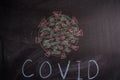 Chalk drawing of a virus COVID-19 on the background of blackboard. Back to school Royalty Free Stock Photo