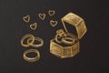Chalk drawing of wedding rings, an engagement ring in a box, and floating hearts on a blackboard background Royalty Free Stock Photo