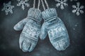 Chalk drawing of winter mittens with snowflake patterns on a textured dark background Royalty Free Stock Photo