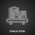 Chalk Hand truck and boxes icon isolated on black background. Dolly symbol. Vector