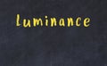 College chalk desk with the word luminance written on in