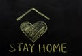 Chalk inscription on blackboard `stay home`