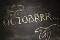 The chalk inscription OCTOBRRR, intentionally misspelling the word October, symbolizes the onset of cold weather in