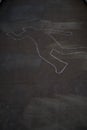 Chalk outline of person on cement