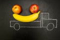 Chalk painted truck loaded with bananas and apples on a black background