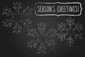 Chalk snowflakes and Season`s greetings Royalty Free Stock Photo