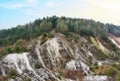 Chalk structure on artificial mountain after quarry mining. Technogenic rock formed during mine. Mountain hill with chalk fossil