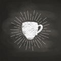 Chalk textured coffee cup silhouette with vintage sun rays on black board. Royalty Free Stock Photo