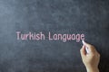 Chalk word Turkish Language on a board with hand