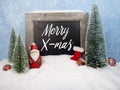 Chalkboard with christmas decoration with snow and snowflakes with message Merry X-Mas