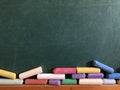 Blank chalkboard with coloured chalks Royalty Free Stock Photo