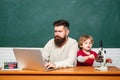 Chalkboard copy space. father teaching her son in classroom at school. Copy space. Teacher helping young boy with lesson Royalty Free Stock Photo