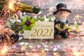 Chalkboard with four leaf clover and chimney sweeper and sparklers with happy new year 2021 on wooden background