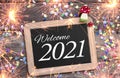 Chalkboard with four leaf clover and chimney sweeper and sparklers with happy new year 2021 on wooden background