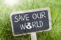 Chalkboard in the grass with save our world Royalty Free Stock Photo