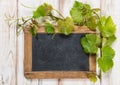 Chalkboard green vine leaves decoration bright wooden background Royalty Free Stock Photo