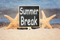 Chalkboard with inscription Summer Break on sand near sea. School Holidays Royalty Free Stock Photo