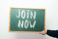 Chalkboard with JOIN NOW handwritten in chalk Royalty Free Stock Photo