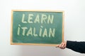 Chalkboard with LEARN ITALIAN handwritten in chalk Royalty Free Stock Photo