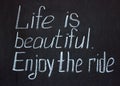 Chalkboard lettering `Life is beautiful. Enjoy the ride`