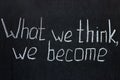 Chalkboard lettering `What we think, we become`