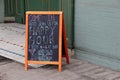 Chalkboard menu inviting folks in for happy hour