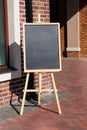 Chalkboard menu standing on the street, sign. Empty space concept for advertising, mockup Royalty Free Stock Photo