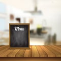 Chalkboard menu on a table against a defocussed cafe interior ba Royalty Free Stock Photo