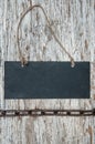 Chalkboard with metal chain on the old wood Royalty Free Stock Photo